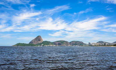 Guanabara Bay at sunny day with white spindrift clouds and Sugarloaf Mountain on the background, Rio De Janeiro, Brazil