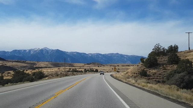 Driving at snowy mountains on route 395, on a sunny november day, near mono lake and lee vining, in California, United states of America