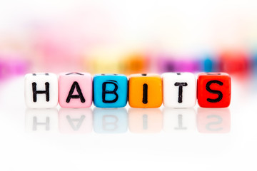 colorful word cube of habits on white background