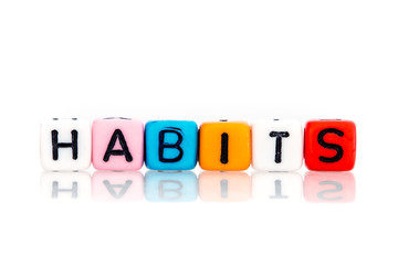 colorful word cube of habits on white background