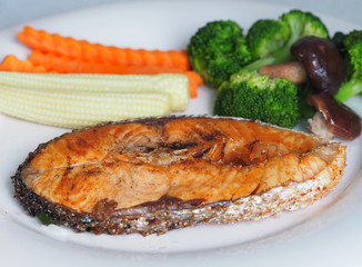 Salmon steak grilled with pepper and mixed vegetables (selective focus)