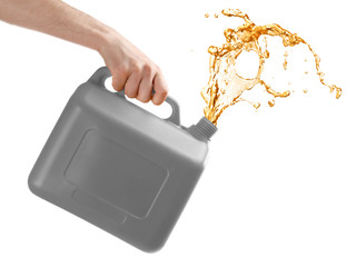 Man pouring oil out of plastic canister on white background