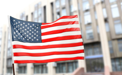 American flag on blurred building background