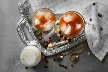 Glasses of cold coffee on silver tray, top view