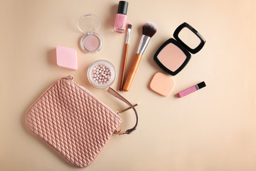 Cosmetic bag and makeup products on color   background