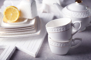 Cups and dishes on grey background
