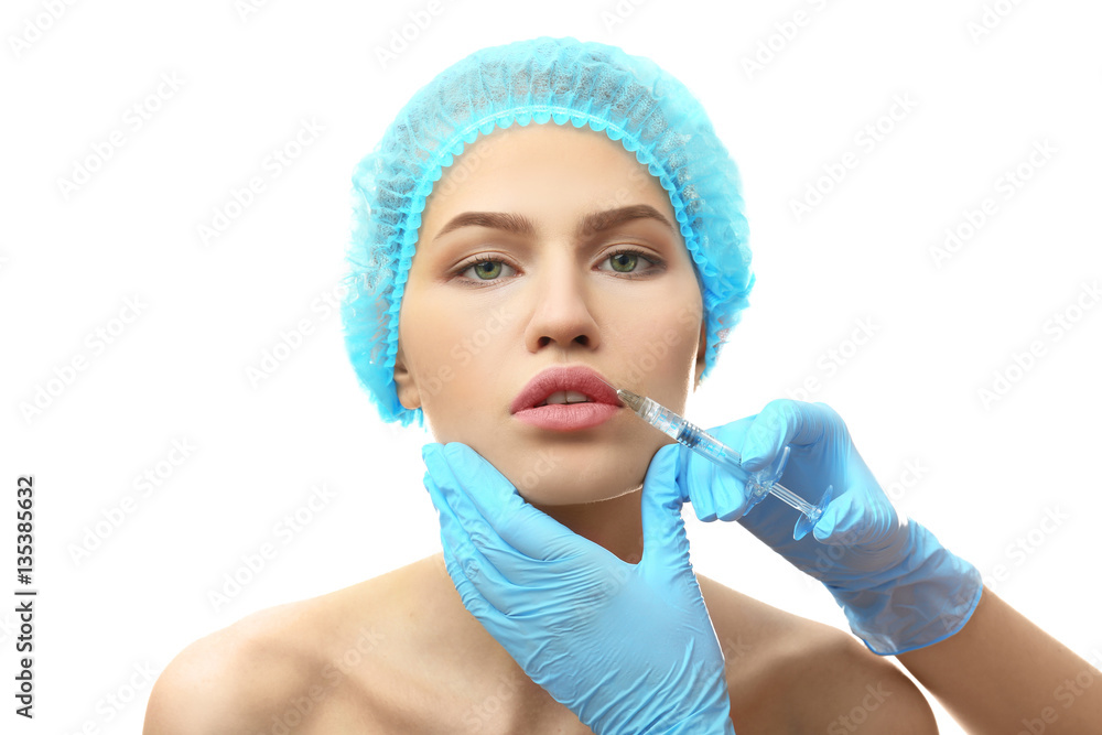 Sticker Young woman having cosmetic injection on white background. Plastic surgery concept