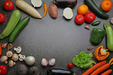 Fresh vegetables on gray background, top view