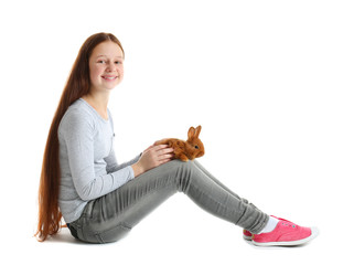 Obraz premium Cute girl holding small rabbit on white background