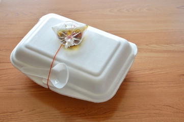 ready meal packing in foam box with plastic spoon and chili fish sauce