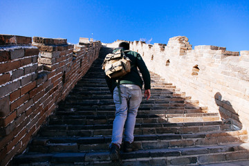 Fototapeta premium Back of Traveler climbing in Great wall of China - Travel in China, Asia concept