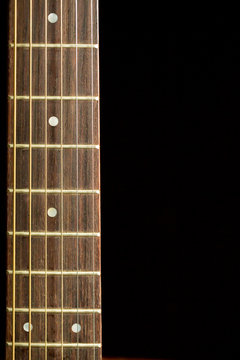 Neck Of Acoustic Guitar On Black Background