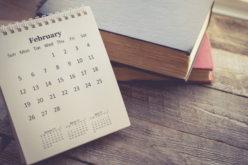 Calendar with the Book on Wooden Background in Vintage Tone