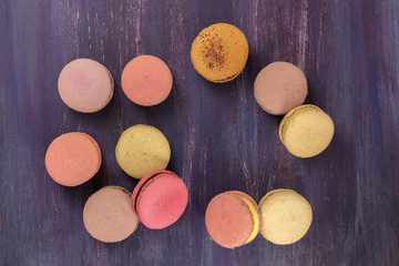 Various macarons on vibrant purple texture