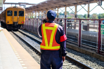 staff man on railroad tracks