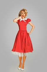 coquettish retro girl in spotted dress