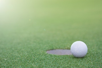 golf ball on lip of cup