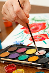 Hand of the artist with paintbrush