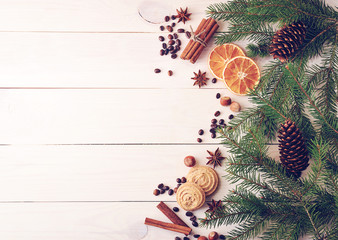 Christmas background with fur-tree branches, cones, dried orange