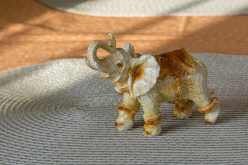 Small decorative ceramic elephant with a raised trunk.