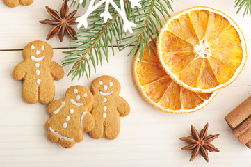 men gingerbread and dried oranges with Christmas tree branches