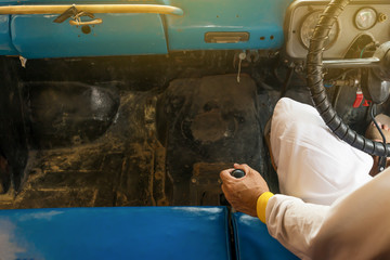 Man hand on manual gear of old car.
Man changing gear while driving a workable vintage old car. 
