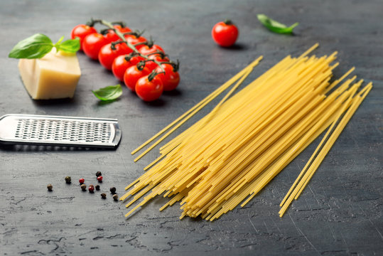 Raw Italian spaghetti with ingredients for cooking classic Itali