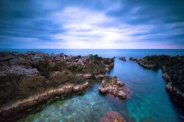 Fototapeta na wymiar Stones in the sea on a long exposure 