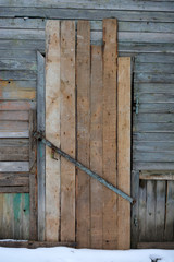 boarded up door in an old wooden abandoned house, texture, background