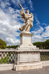 Fototapeta na wymiar Statue of an angel on the bridge over the Tiber river near Vatican in Rome, Lazio region, Italy.