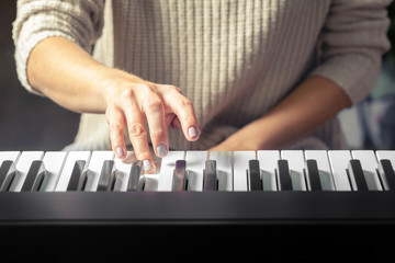 Closeup of hands playing piano. Music and hobby concept