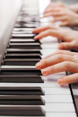 Fototapeta premium Closeup of hands playing piano. Music and hobby concept