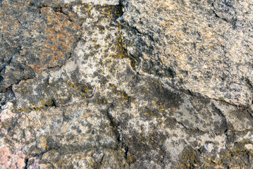 Natural granite rough stone. The old surface close up. Background. Texture.