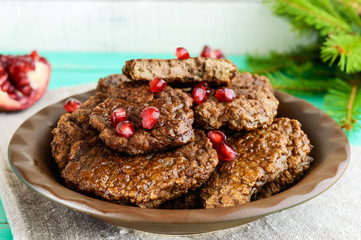 Juicy liver cutlets with pomegranate seeds on a clay bowl. Close up