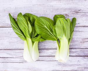 Fresh and raw Chinese cabbage pak choi on wooden background. 