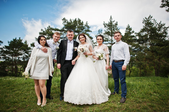Funny and happy wedding couple with bridesmaids and best mans.