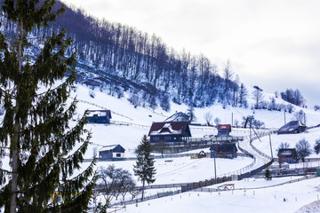 Obraz premium winter landscape with a mountain village in Romania