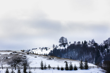 winter landscape with a mountain village in Romania