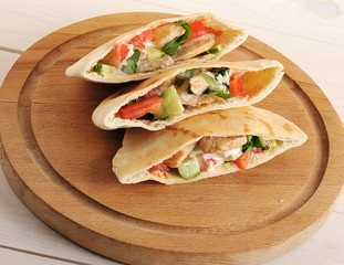 flatbread pita filled with chicken breast, vegetables and sauce