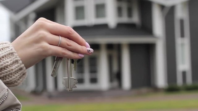 Woman's Hand Showing Keys in a Large Country House