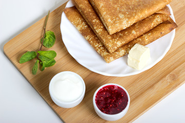 homemade pancakes with butter and maple syrup, closeup toned photo