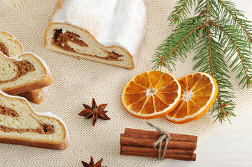 Christmas cake cut into pieces, dried oranges