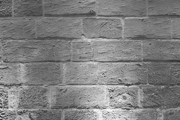 B&W Mediterranean style medieval brick wall background - lighted at night texture