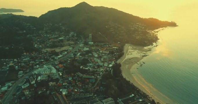 Aerial view of the sea and coastline of the beach at sunset
