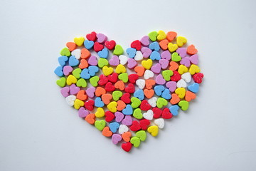 A lot of the little shining colorful hearts in one big heart for Valentine's Day.