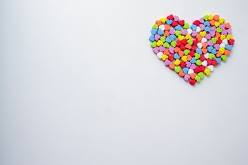 A lot of the little shining colorful hearts in one big heart for Valentine's Day.