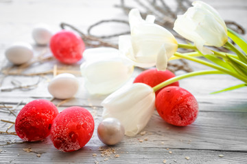White tulips and red Easter eggs
