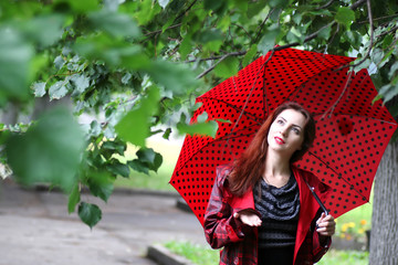 woman in a raincoat and an umbrella