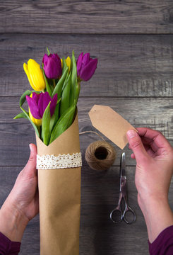 Making a bouquet of yellow and purple tulips