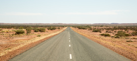 Fototapeta na wymiar Straight road to horizon somewhere in the Australian Outback